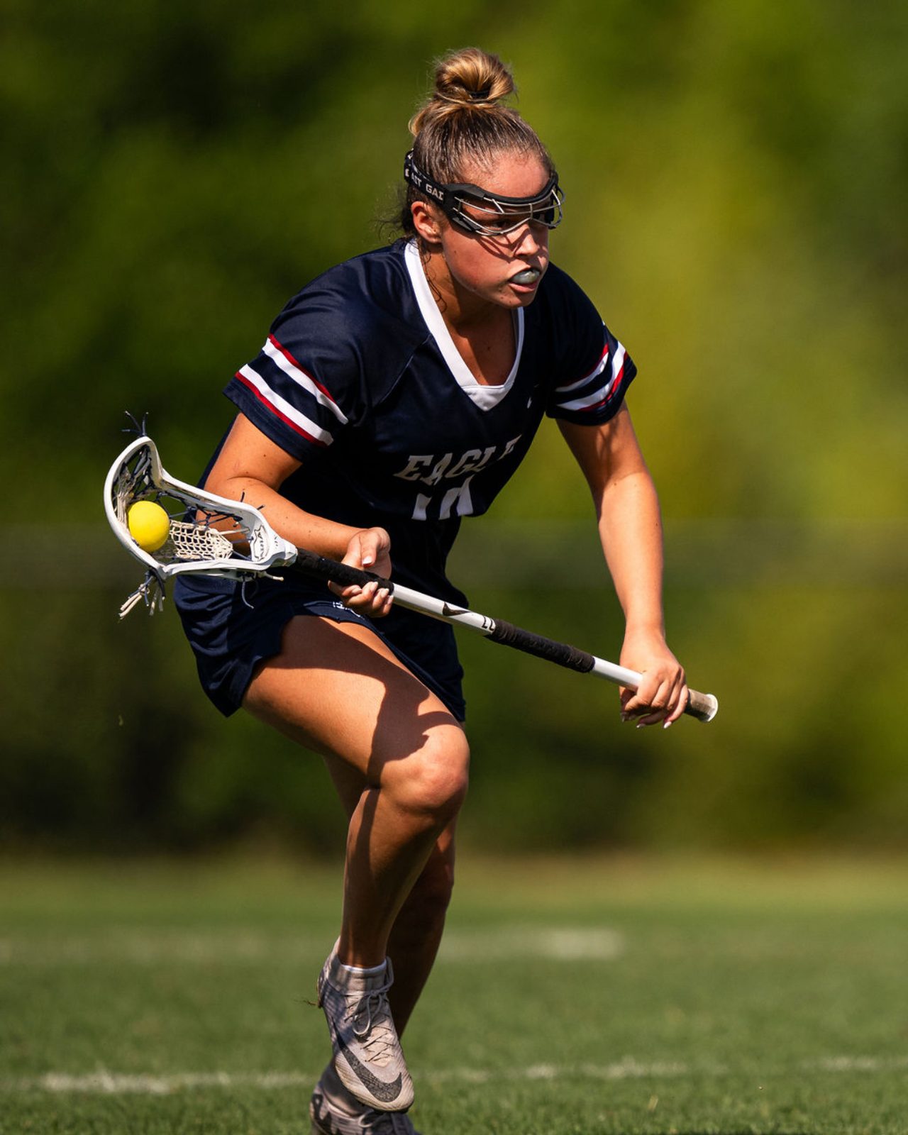 Courtney Del-Cid driving upfield with the ball in her stick